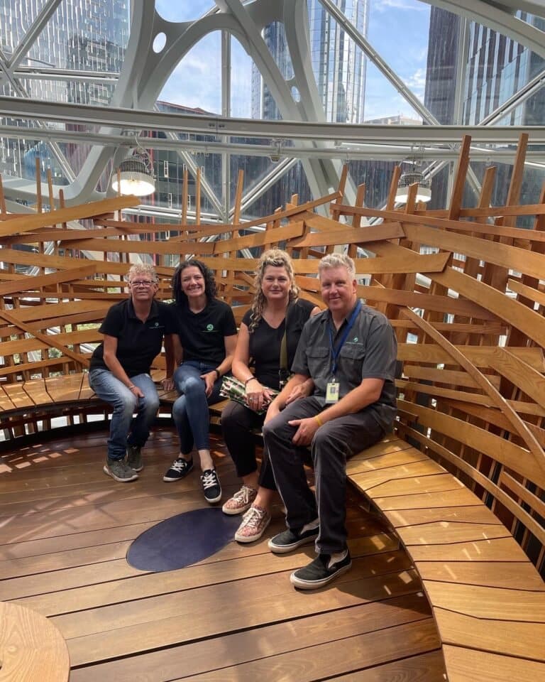 Seattle Plant Company crew photographed together in front of a lush interior planting.