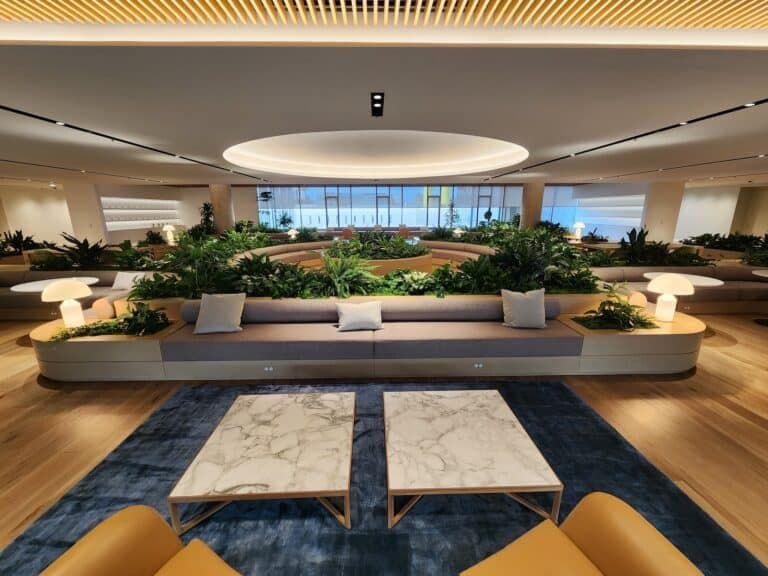 Contemporary office interior with integrated planters and abundant indoor greenery.